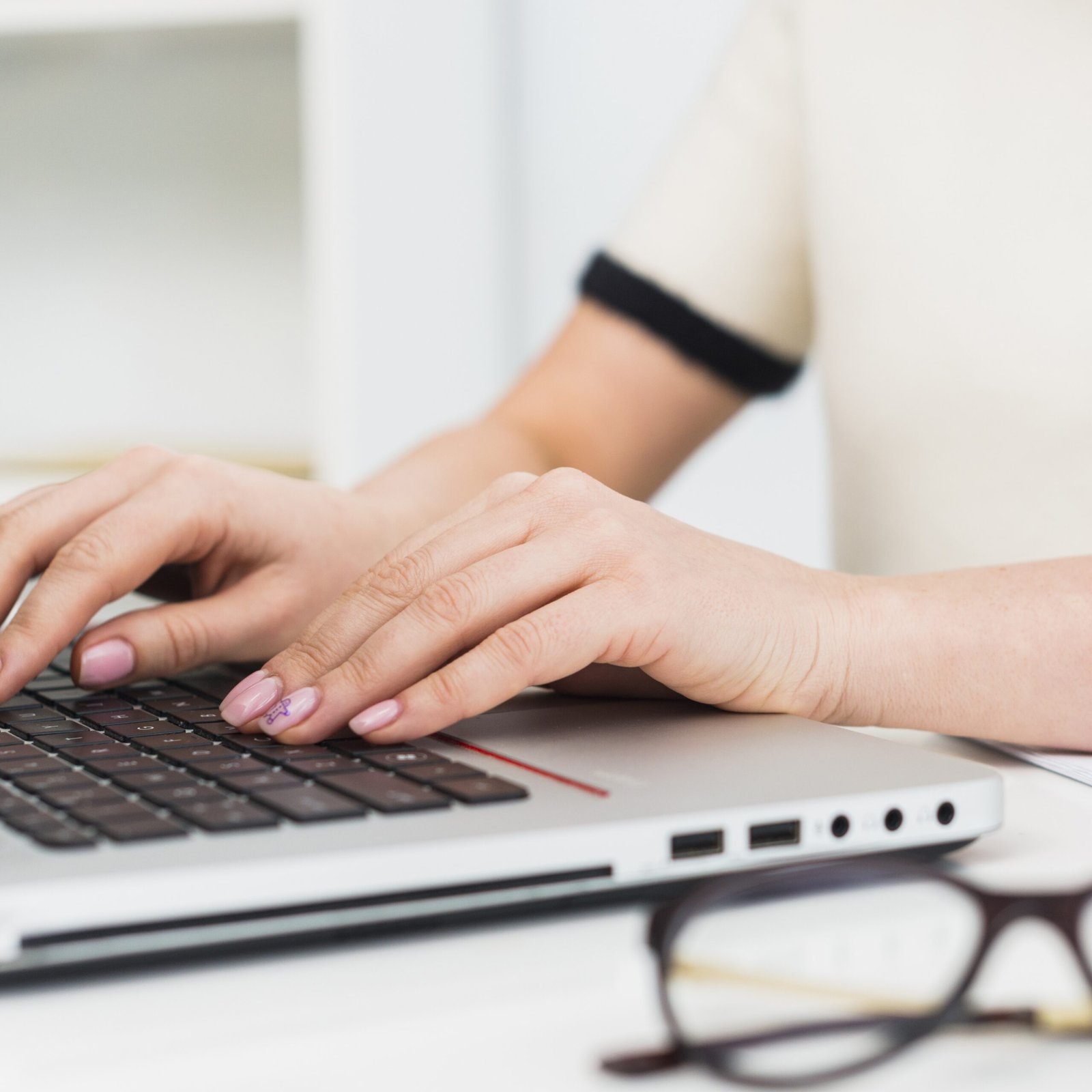 woman light typing laptop keyboard